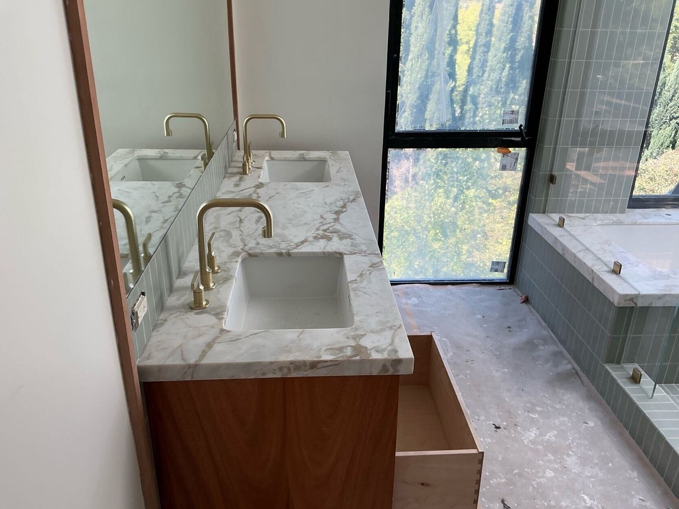 Primary bath with marble vanity and brass fittings